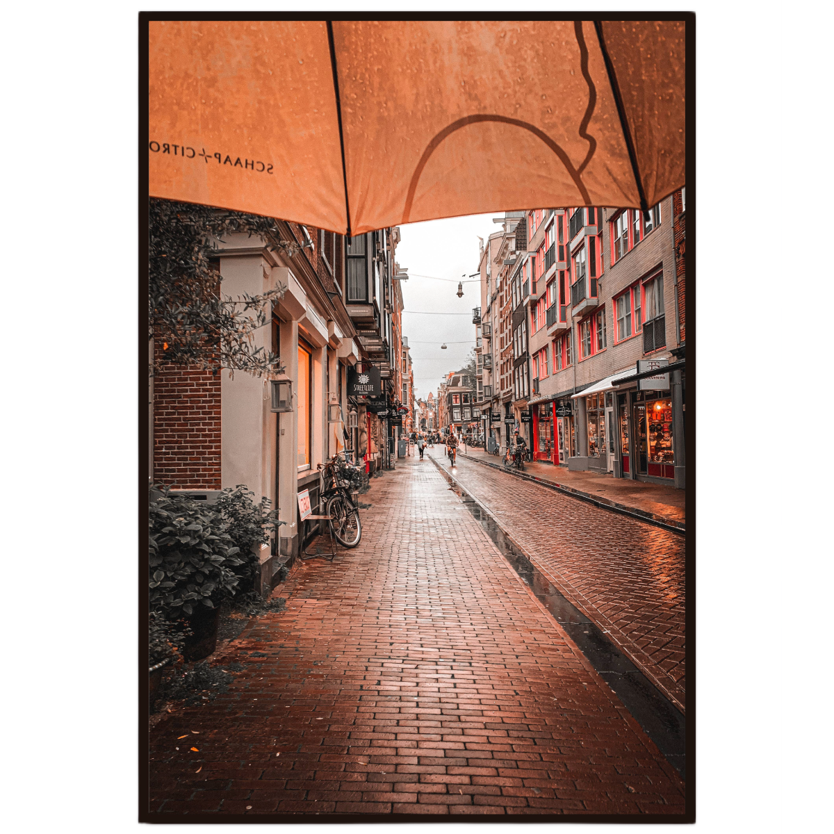 Amsterdam wall art featuring a rain soaked street scene with warm reflections after rainfall.