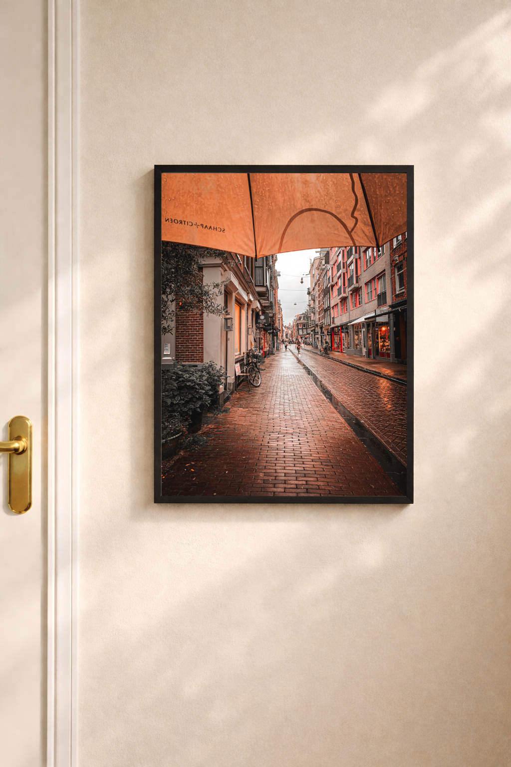Amsterdam wall art featuring a rain soaked street scene with warm reflections after rainfall.