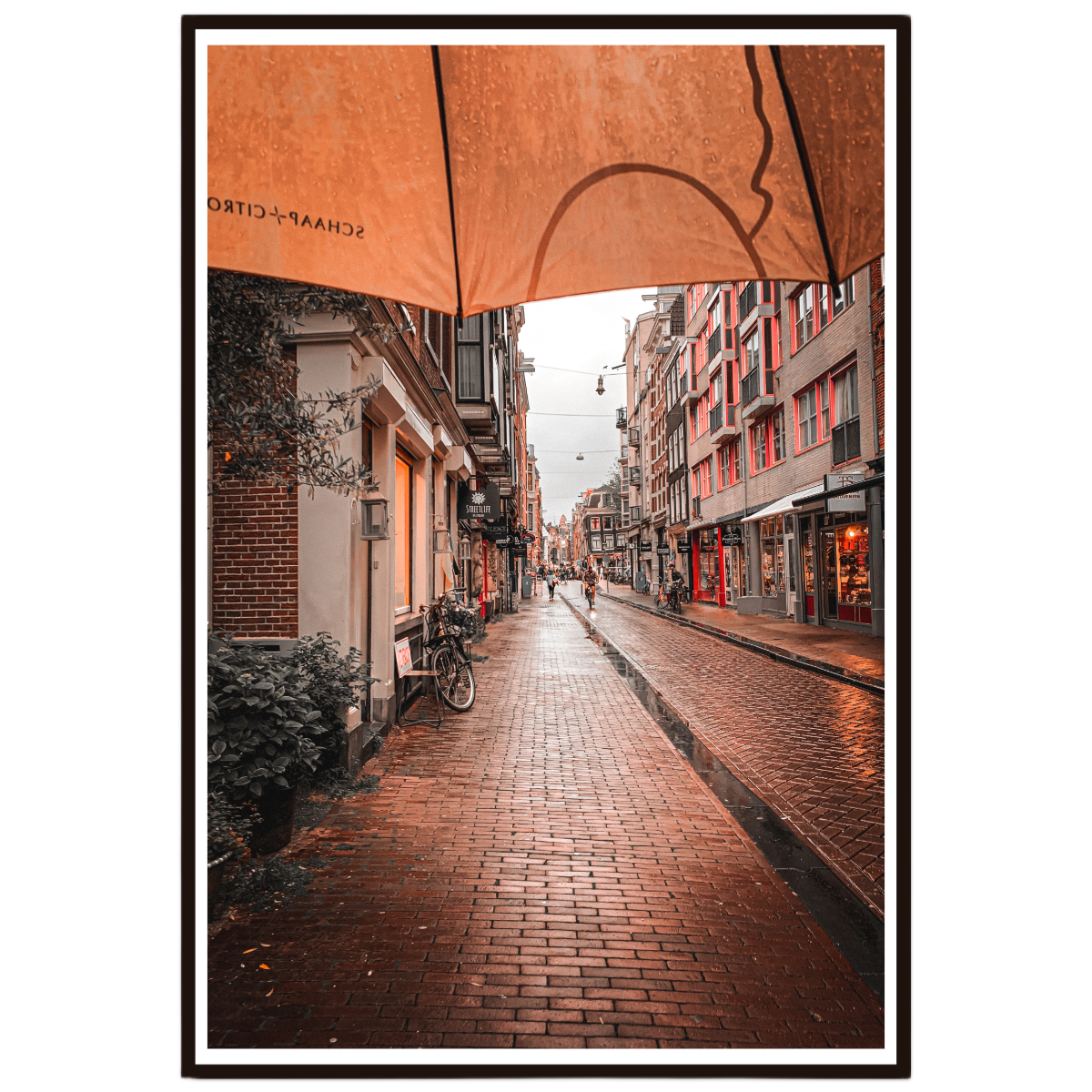 Amsterdam wall art featuring a rain soaked street scene with warm reflections after rainfall.