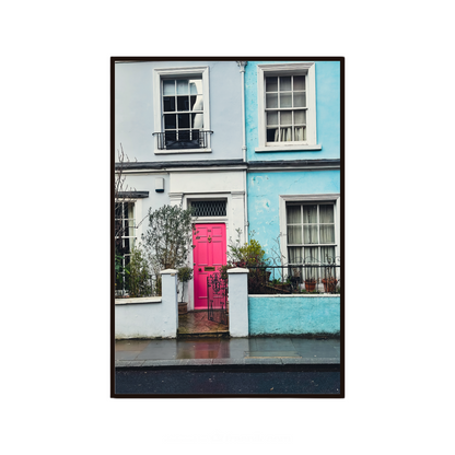 Colourful wall art featuring a bright pink door and pastel houses in London.