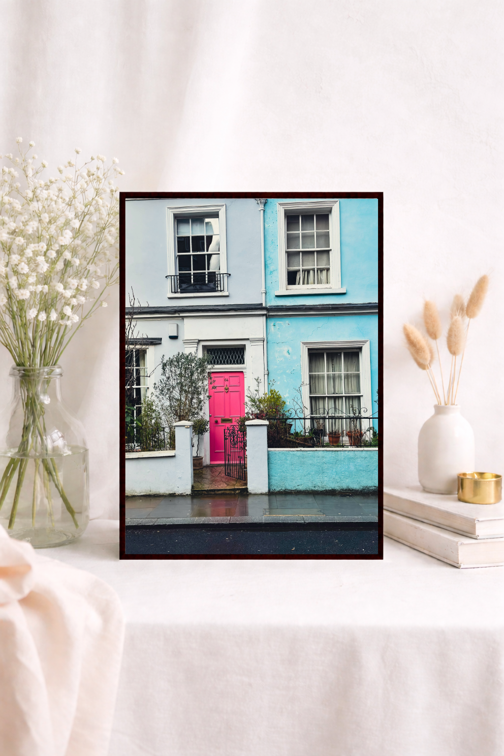 Colourful wall art featuring a bright pink door and pastel houses in London.